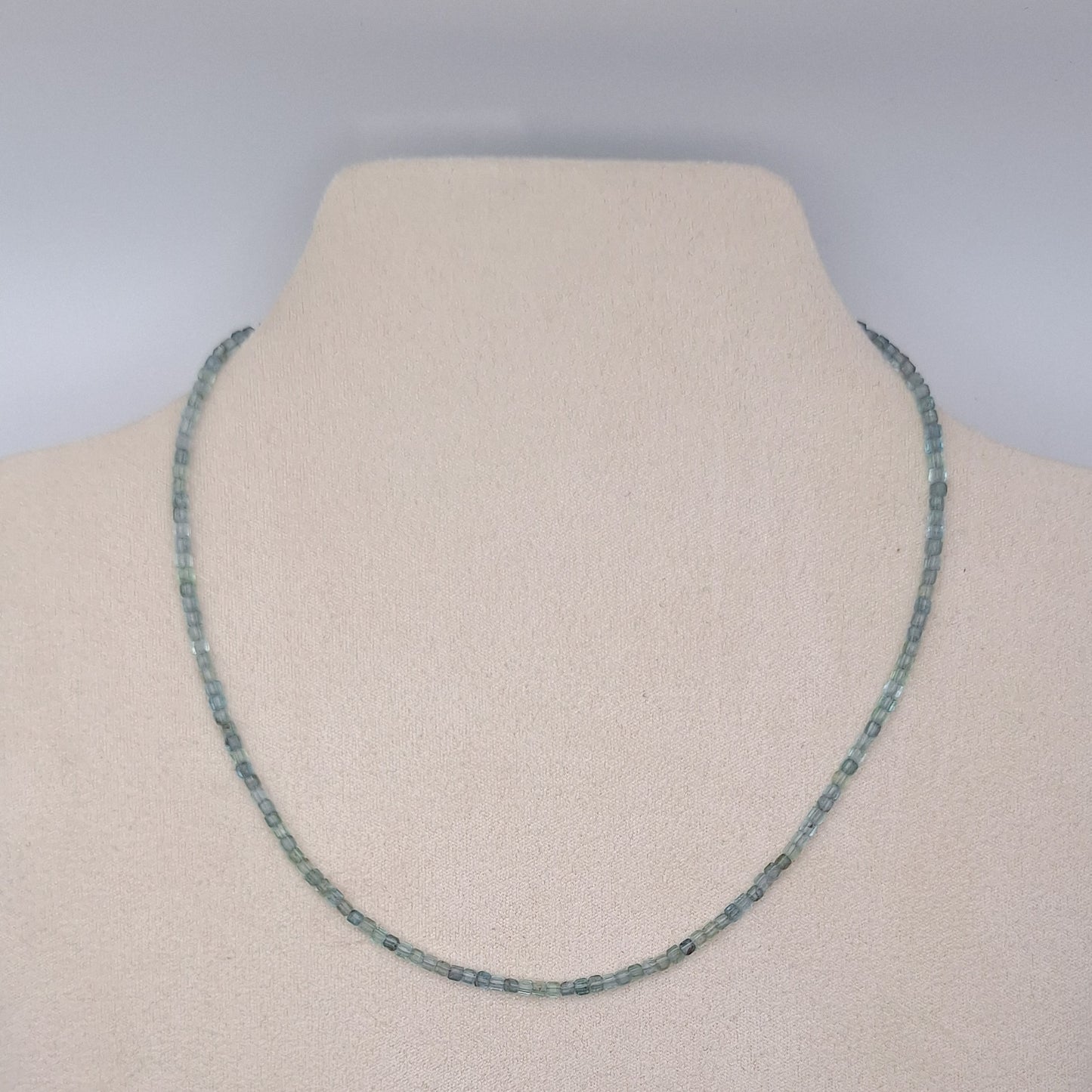 Necklace on a mannequin with a plain background