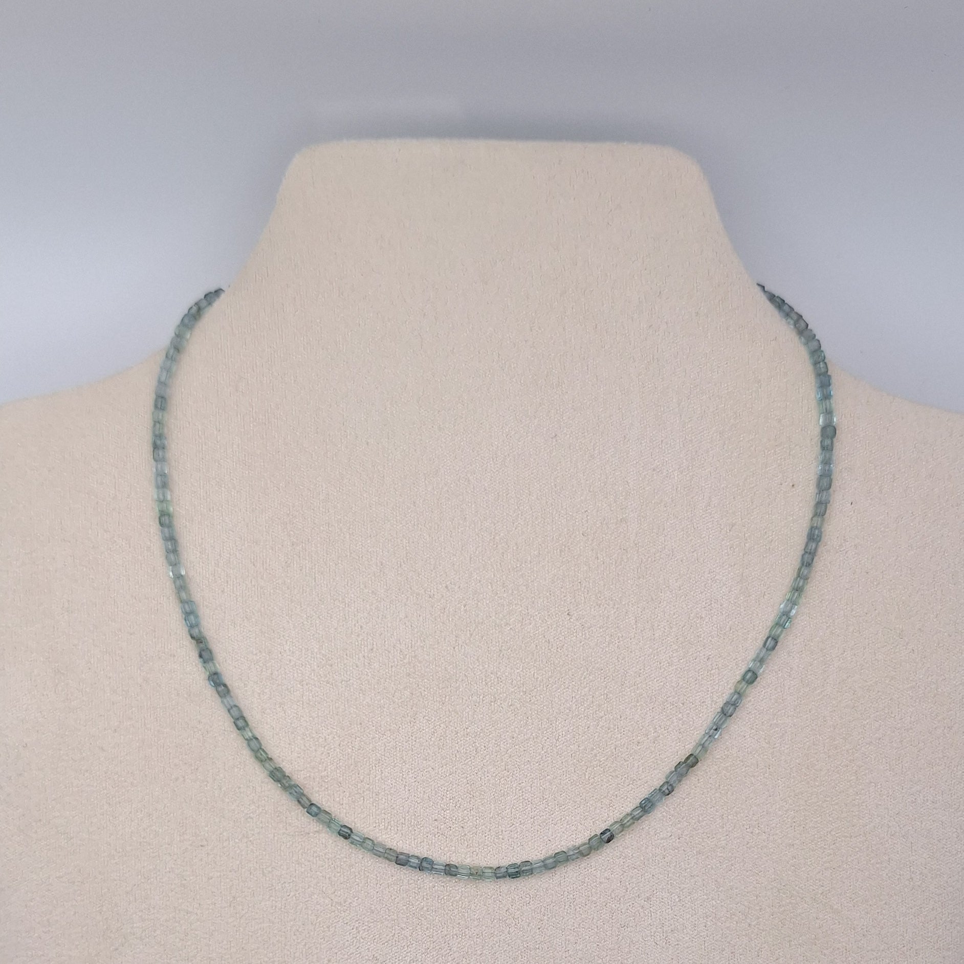 Necklace on a mannequin with a plain background