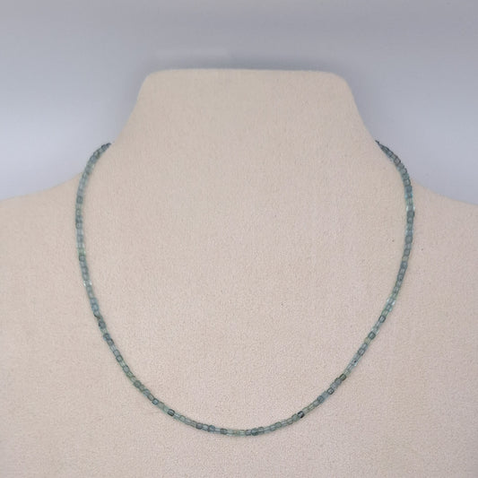 Necklace on a mannequin with a plain background